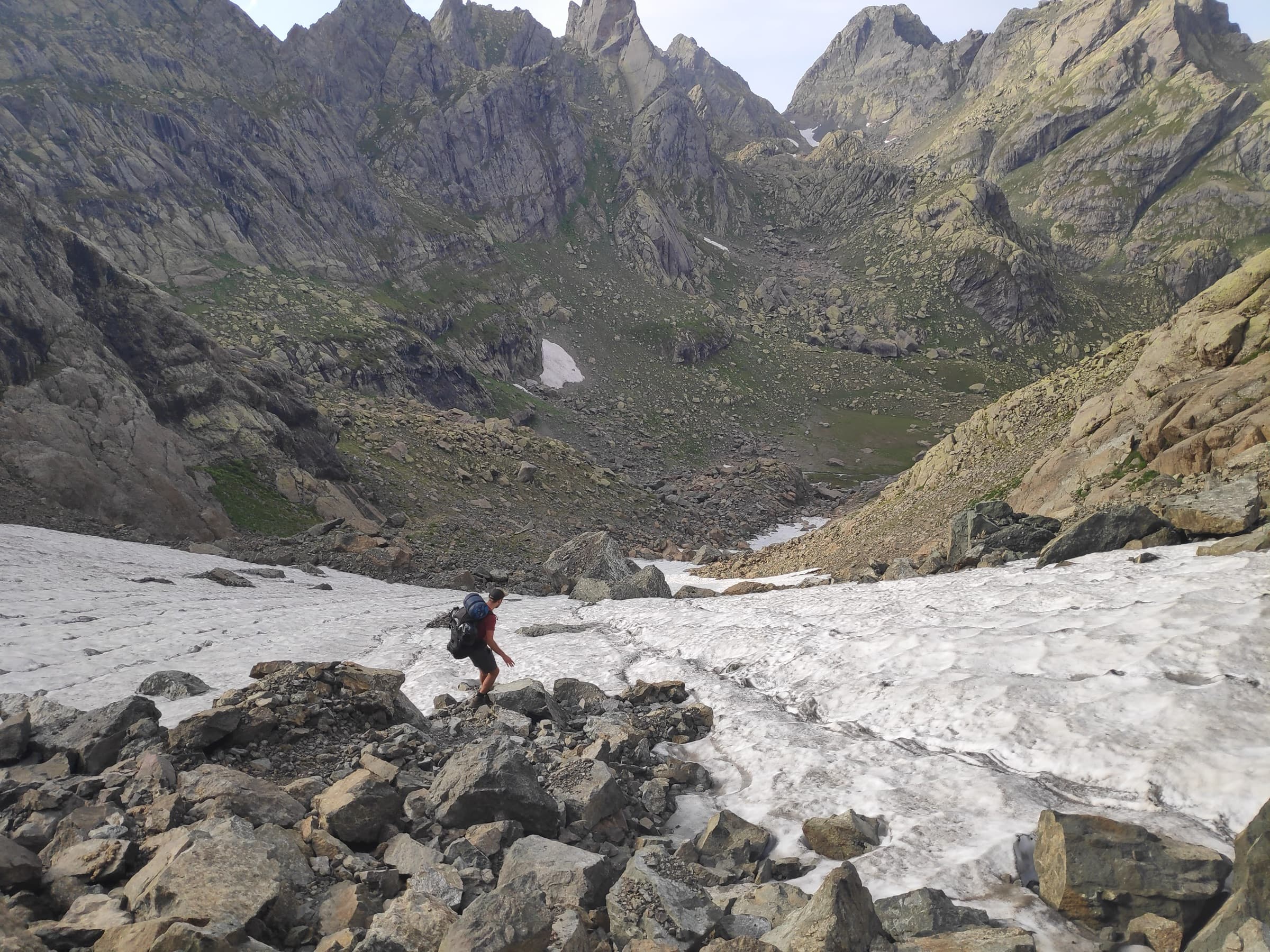 A lone hiker crossing the tongue of a glacier