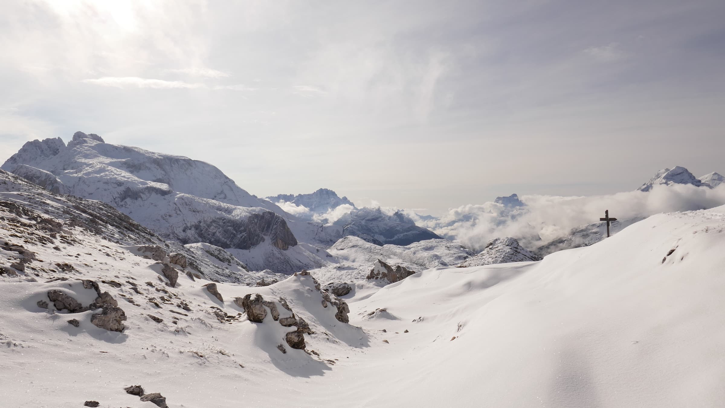 A wide snow slope under flat white light