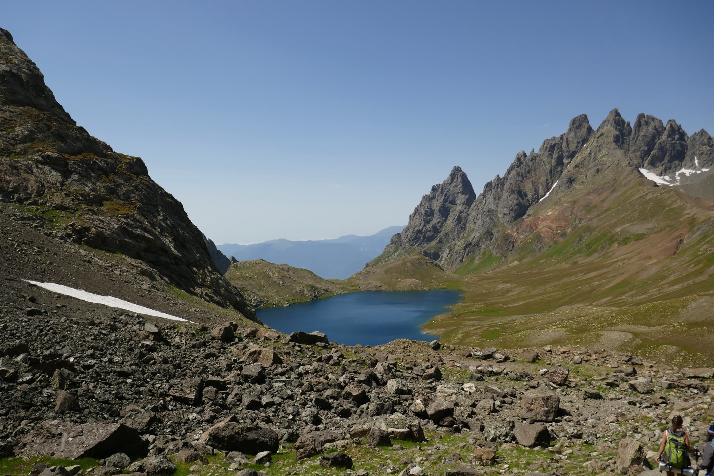 An alpine lake in a rocky cirque below jagged peaks