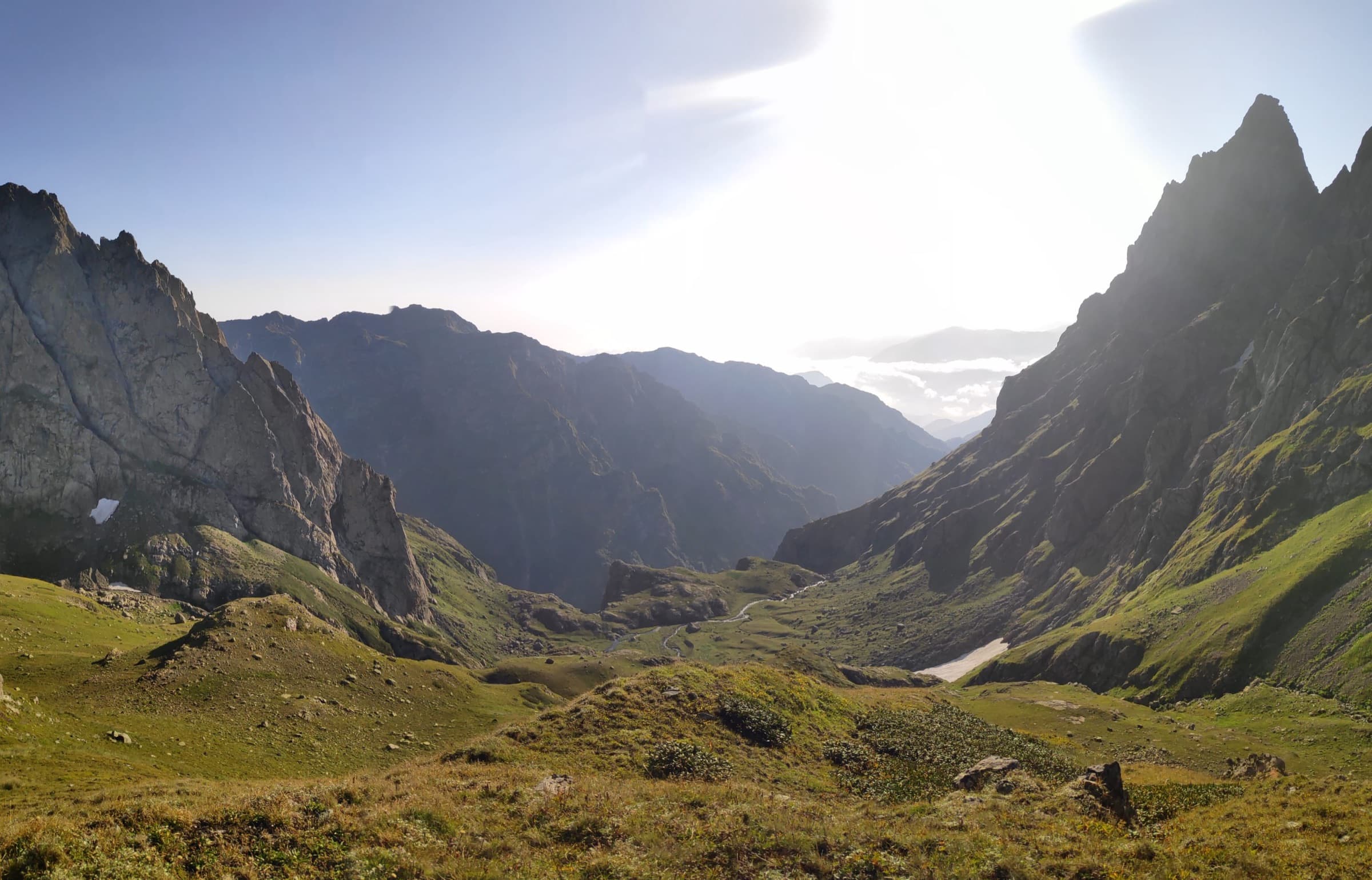 An evening panorama over a deep valley from a high camp