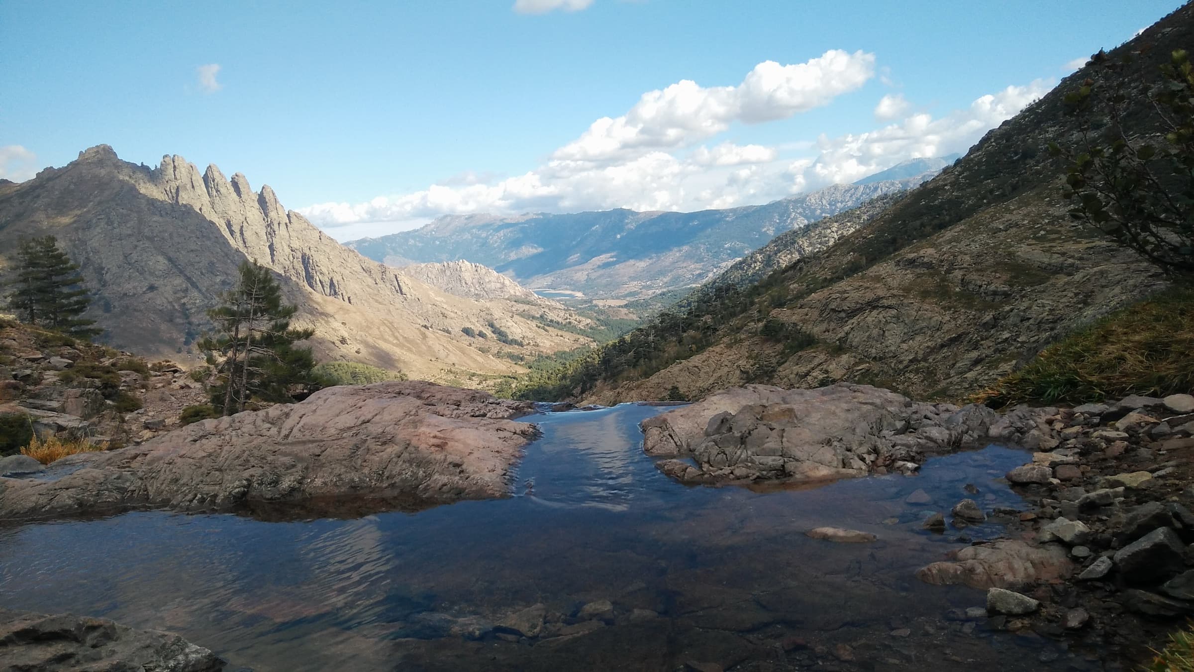 A dark mountain tarn cupped between rocky ridges