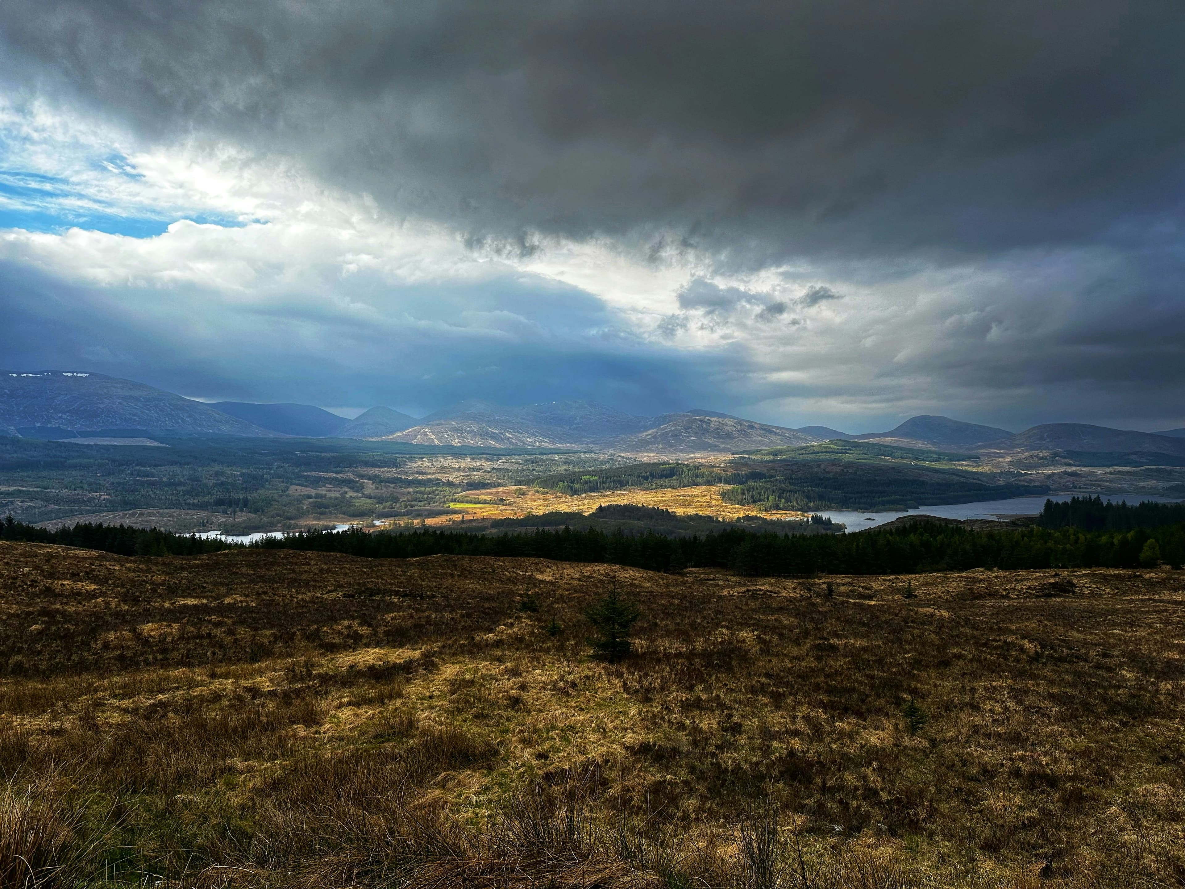 Wild camping tent beside a Scottish loch in the Highlands at dawn